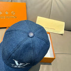 Blue denim baseball cap with round top button and small rear logo