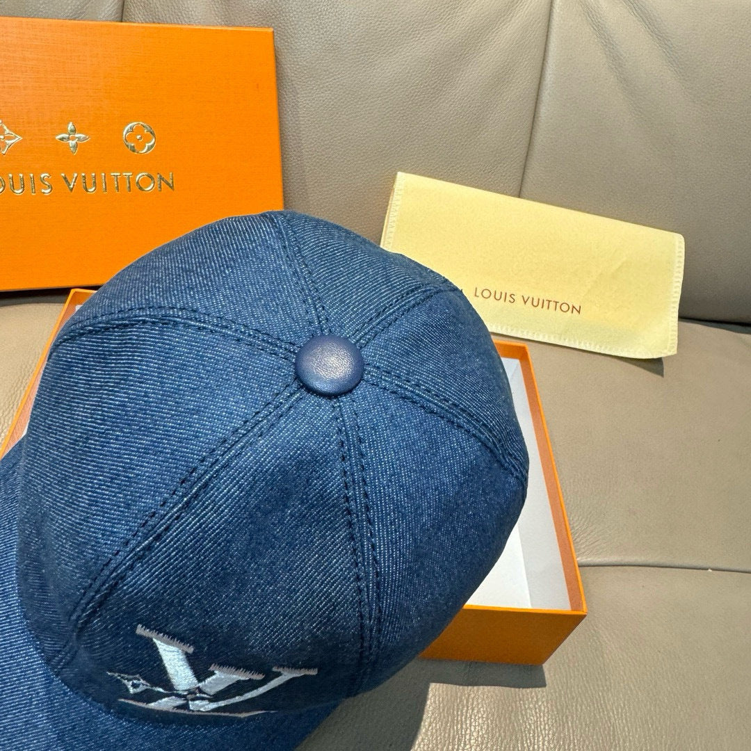 Blue denim baseball cap with round top button and small rear logo