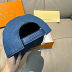Blue denim baseball cap with adjustable inner strap and metal button