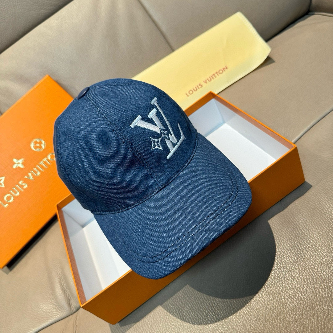 Blue denim baseball cap with white LV-style logo on front