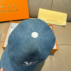 Blue denim baseball cap back view with top button and stitched seams.