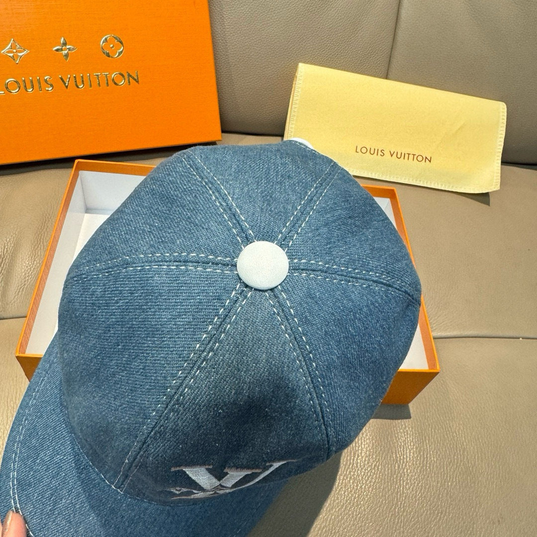 Blue denim baseball cap back view with top button and stitched seams.
