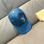 Blue denim baseball cap angled view with LV logo embroidery and top button.