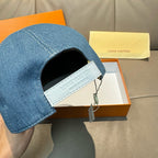 Blue denim baseball cap brim opening with interior label visible.