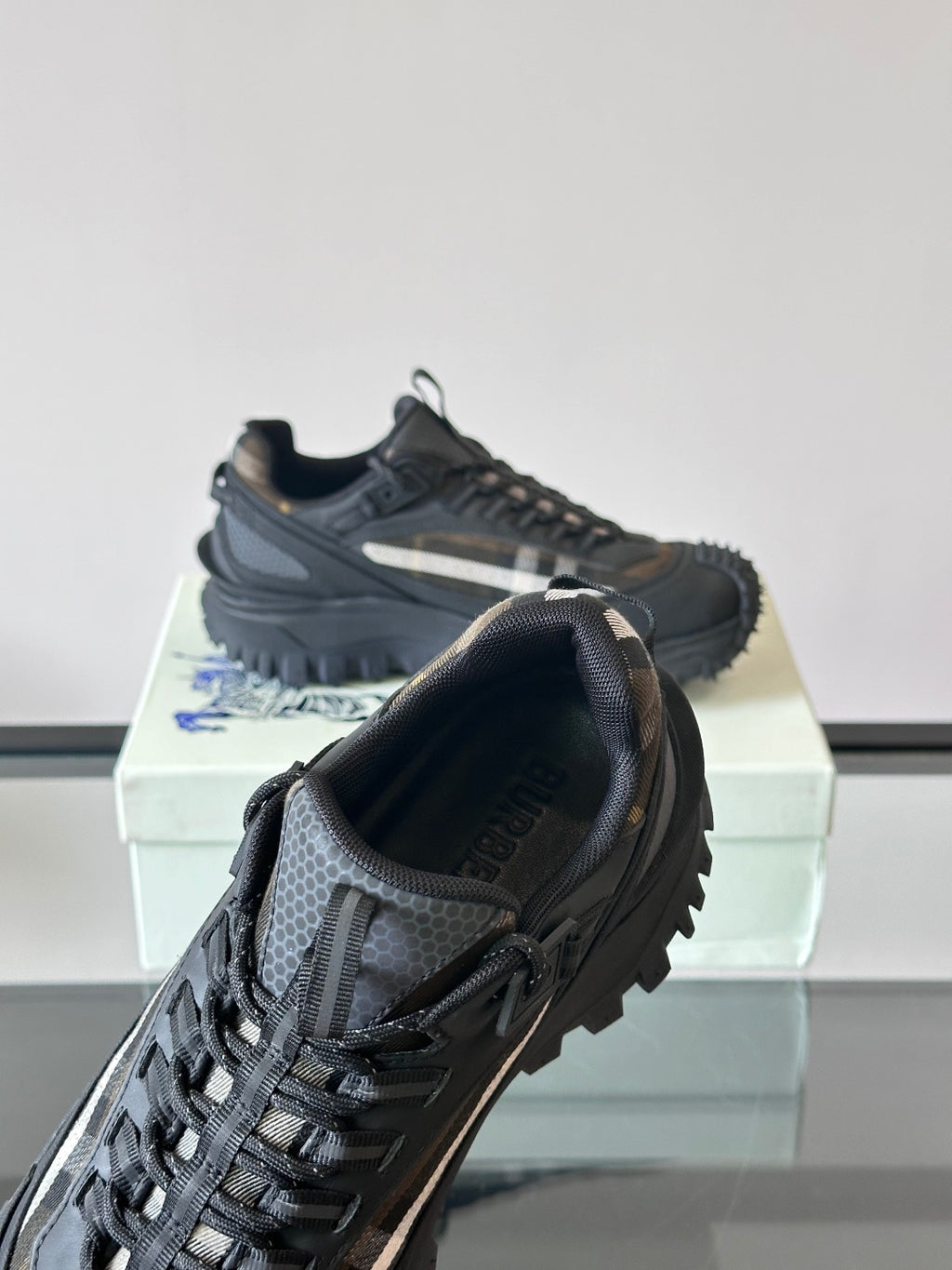 Black lace-up chunky sneaker with check-style side panel and webbed upper detail