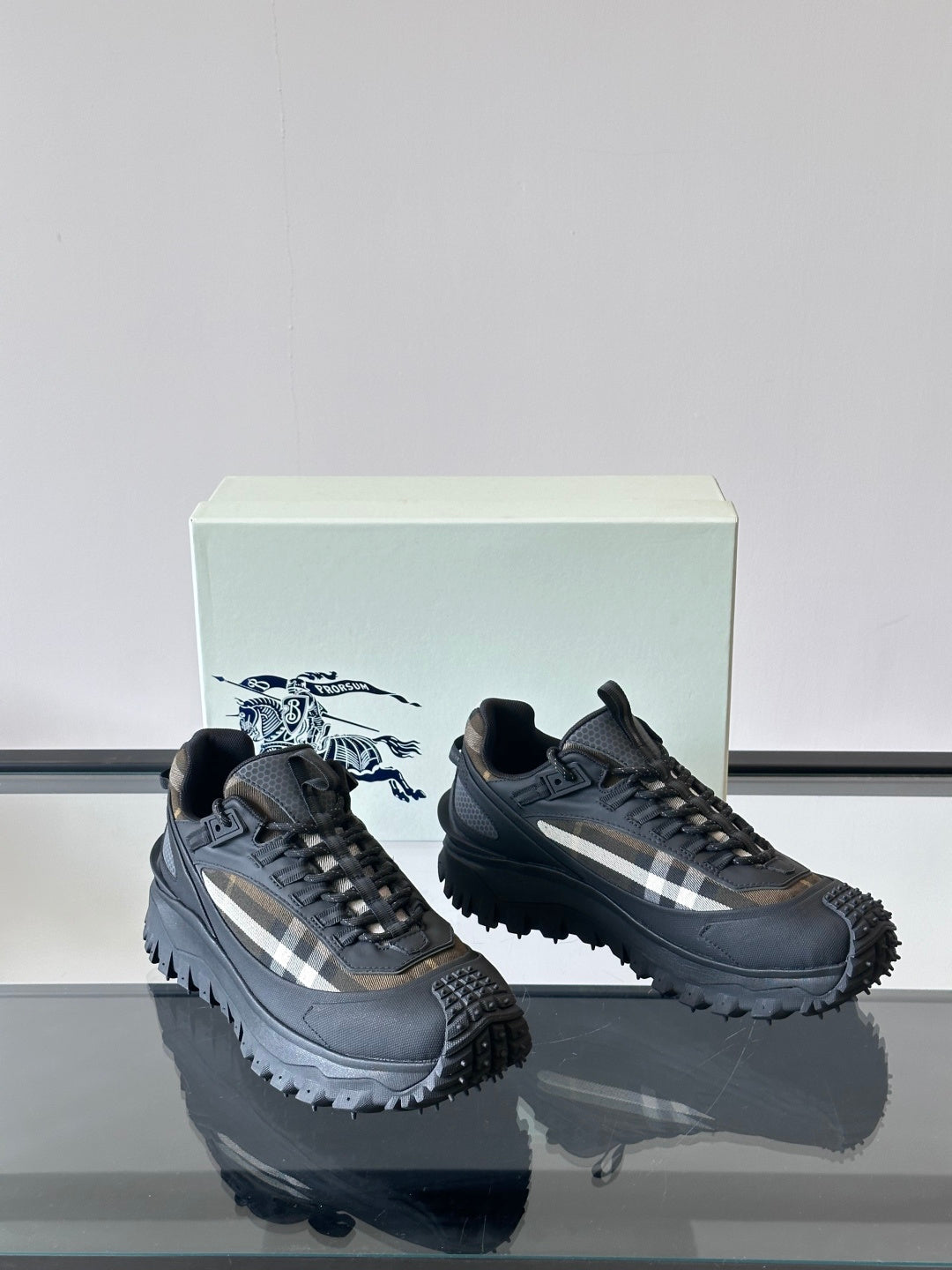 Black lace-up chunky sneakers with check-style side panel and serrated outsole