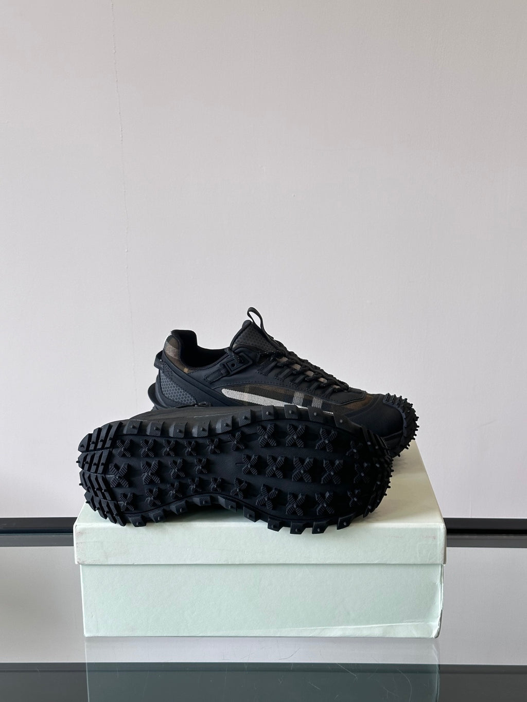 Black lace-up chunky sneakers with rugged tread sole, shown from the side