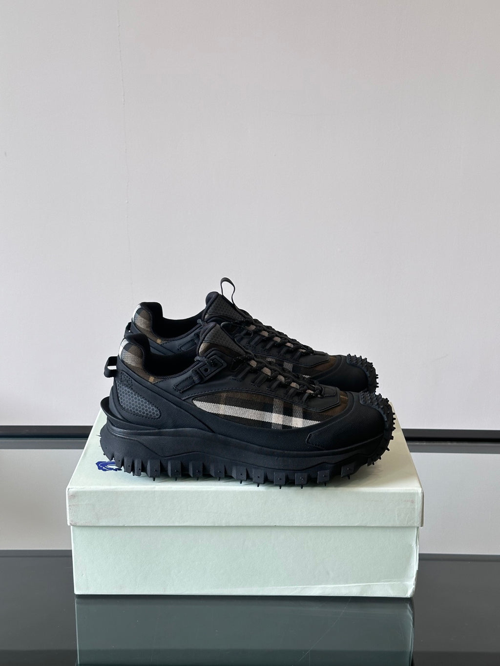 Black lace-up chunky sneakers with check-style side panel and treaded sole