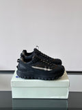 Black lace-up chunky sneakers with check-style side panel and treaded sole