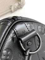 Black monogram duffel bag leather handle detail with metal ring and stitching