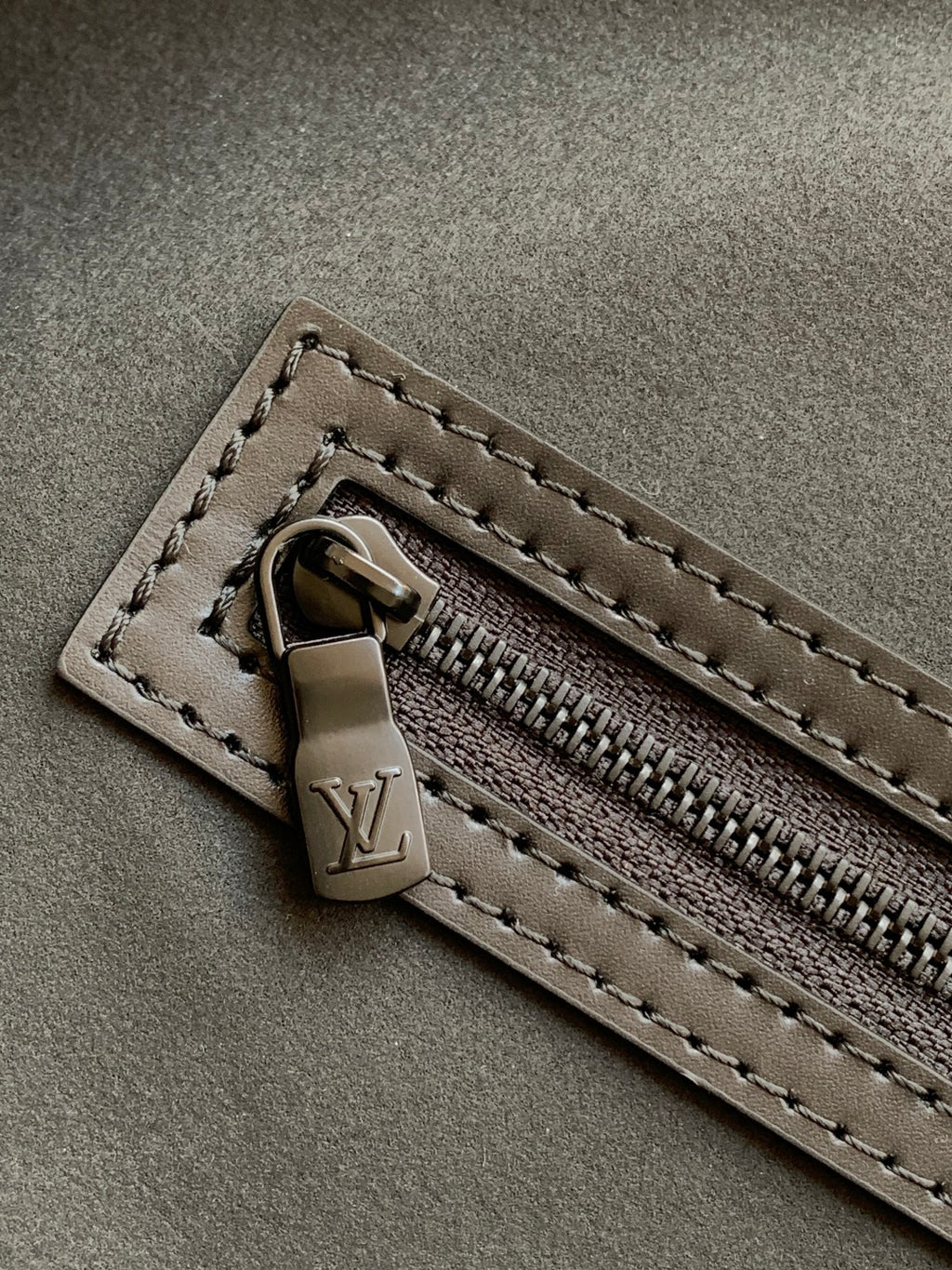 Black monogram duffel bag zipper pull and track with leather tab detail