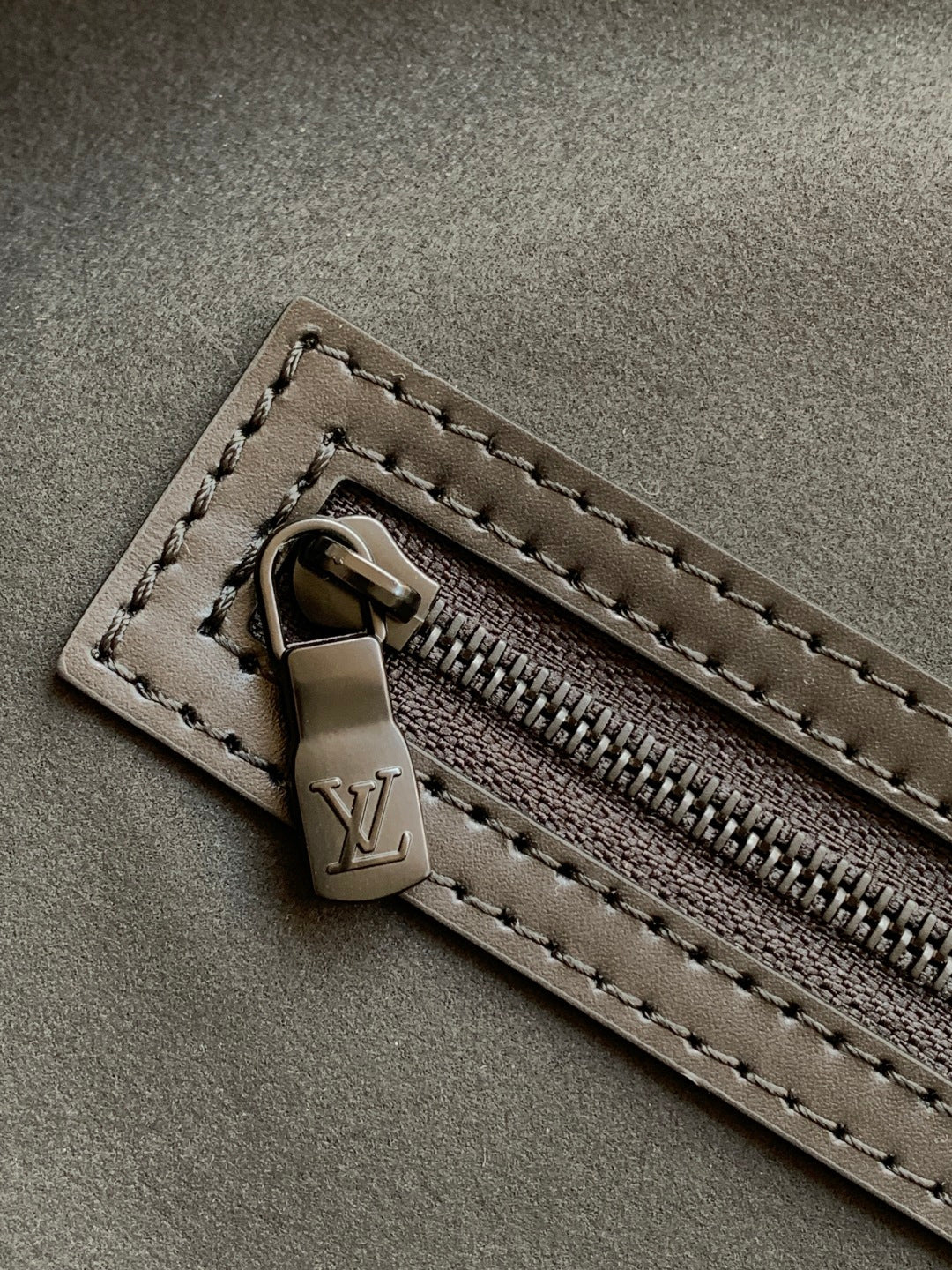 Black monogram duffel bag zipper pull and track with leather tab detail