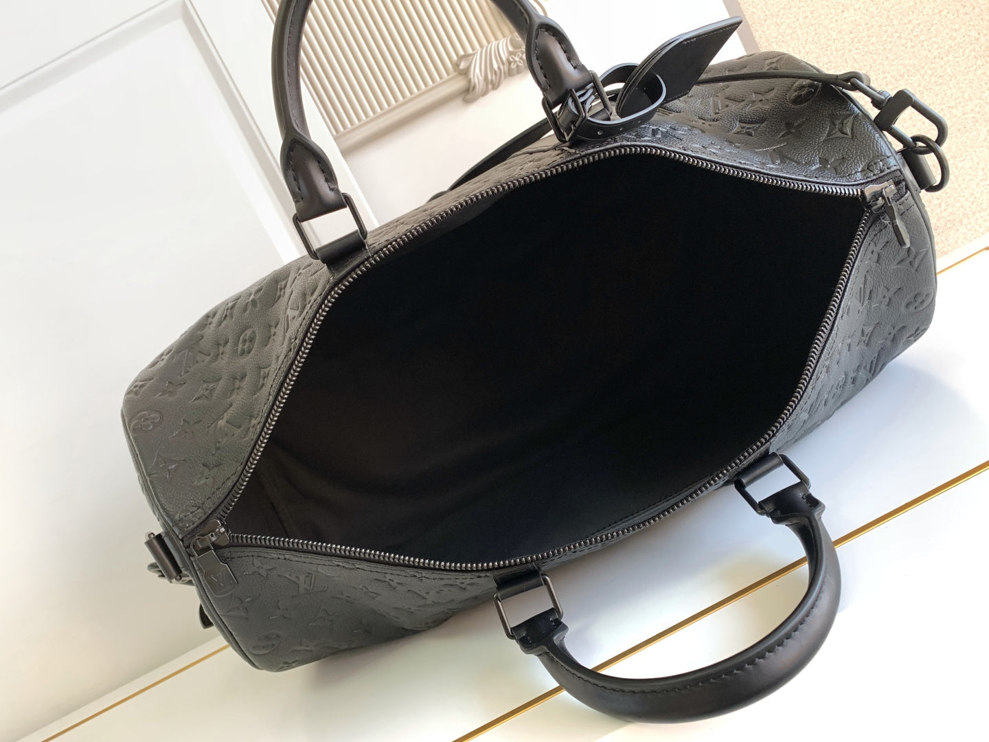 Black monogram duffel bag open top with zipper track and interior lining