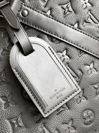 Black monogram duffel bag front leather patch with snap strap detail