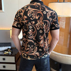 Back view of short-sleeve polo shirt with black base and gold-orange ornate print