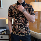 Polo shirt with black collar and front placket, covered in gold-orange ornate print