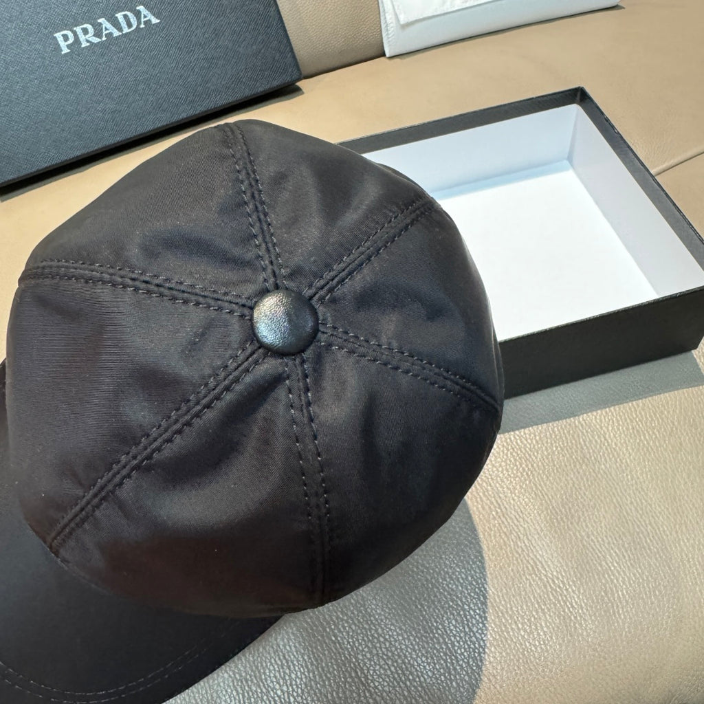 Dark navy PRADA baseball cap, top view with center button and diamond stitch lines