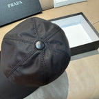 Dark navy PRADA baseball cap, top view with center button and diamond stitch lines