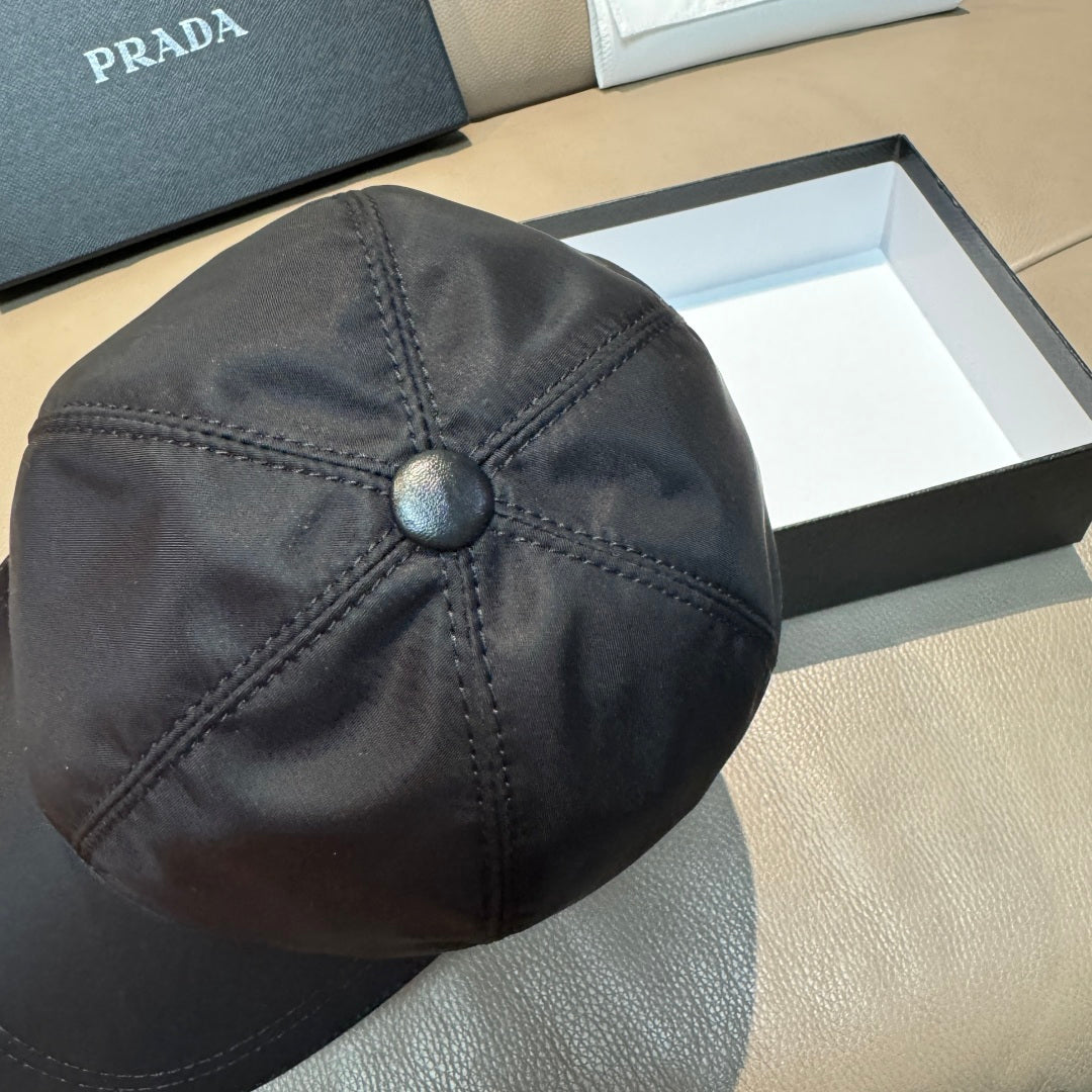 Dark navy PRADA baseball cap, top view with center button and diamond stitch lines