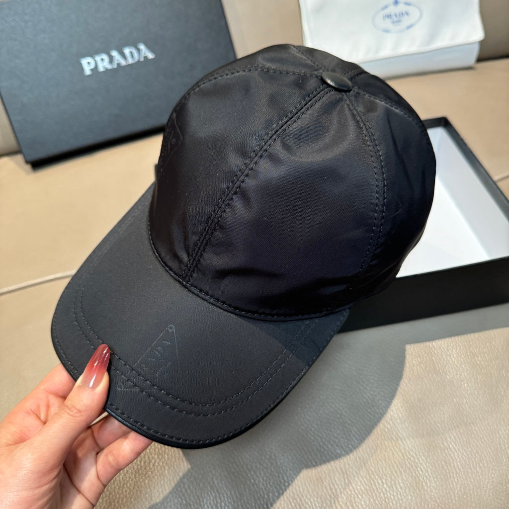 Dark navy PRADA baseball cap, front panel with small logo mark and stitching