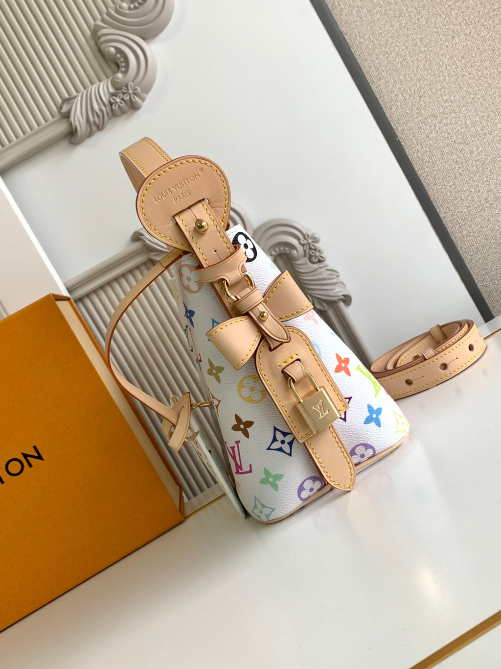 Louis Vuitton multicolor monogram mini handbag with tan crossbody strap and buckle