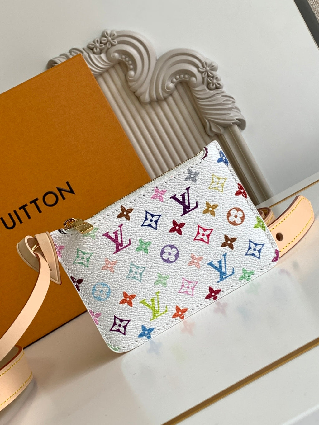 Louis Vuitton multicolor monogram mini handbag with tan strap and front pocket detail