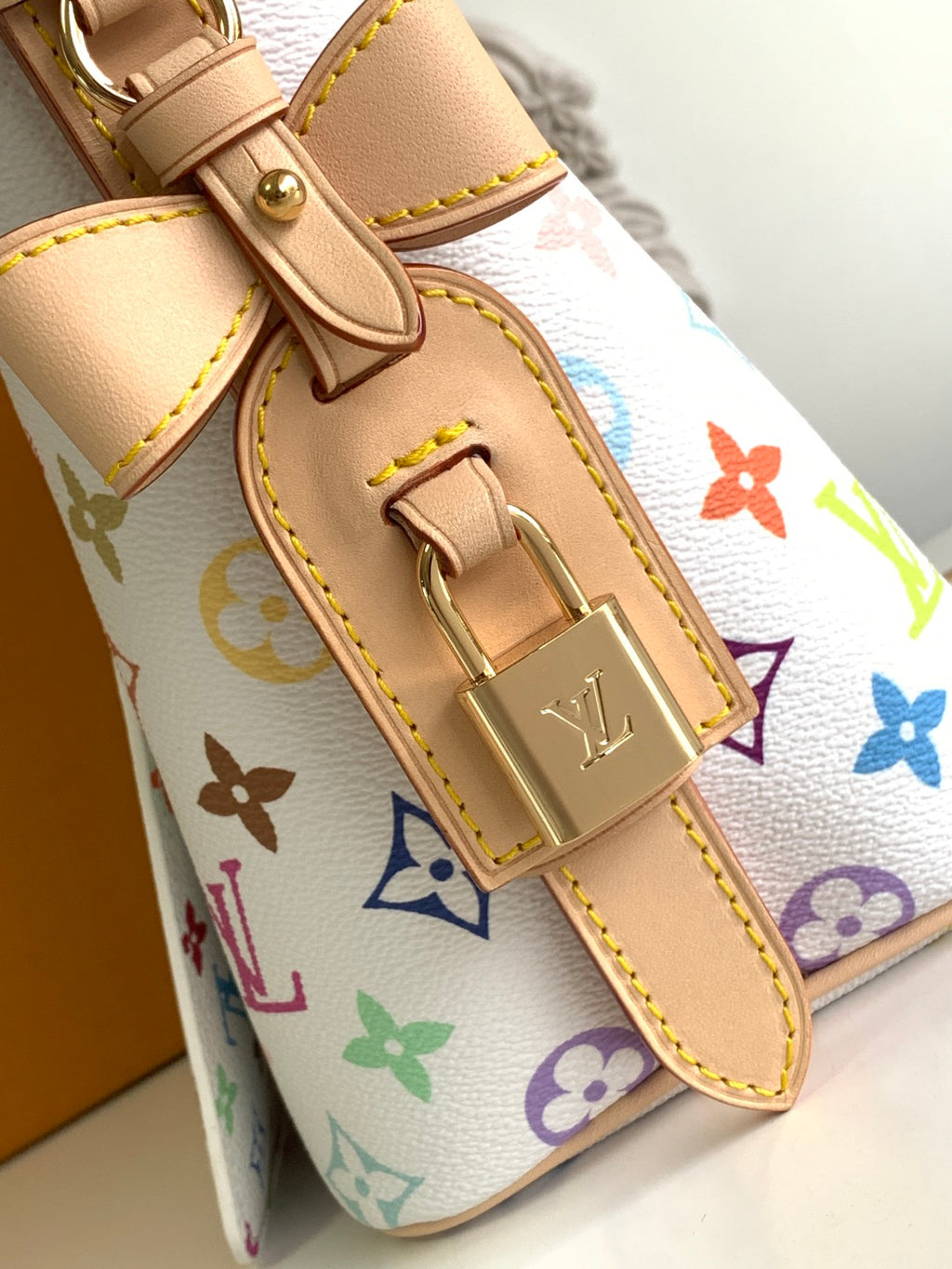Louis Vuitton multicolor monogram mini bag close-up of tan leather trim and clasp