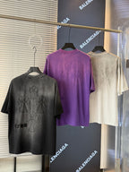 Short-sleeve T-shirts on hangers: black, purple, and cream with embroidered floral designs.