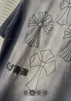 Gray short-sleeve T-shirt fabric with detailed black stitched flower and ribbon embroidery.