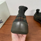 Burberry sneakers rear view, dark knit sock collar and rubber heel