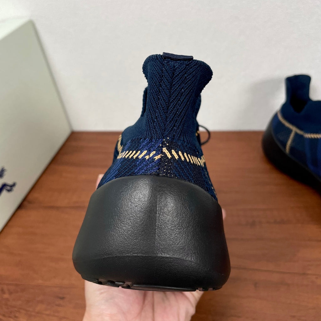 Burberry blue knit sneaker heel with ribbed collar and black rubber sole