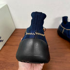 Burberry blue knit sneaker heel with ribbed collar and black rubber sole