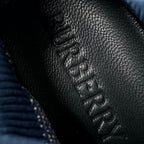 Burberry knit upper texture with black lace-up eyelets close-up