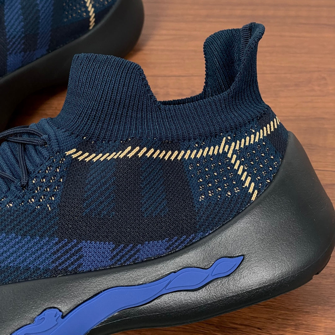 Burberry blue knit sneaker side with blue flame logo and black sole
