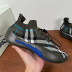 Burberry knit sneaker on hand, black-and-white plaid with blue side stripe