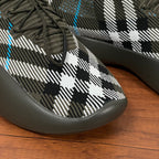 Burberry knit sneaker toe close-up, black-and-white plaid with dark rubber edge