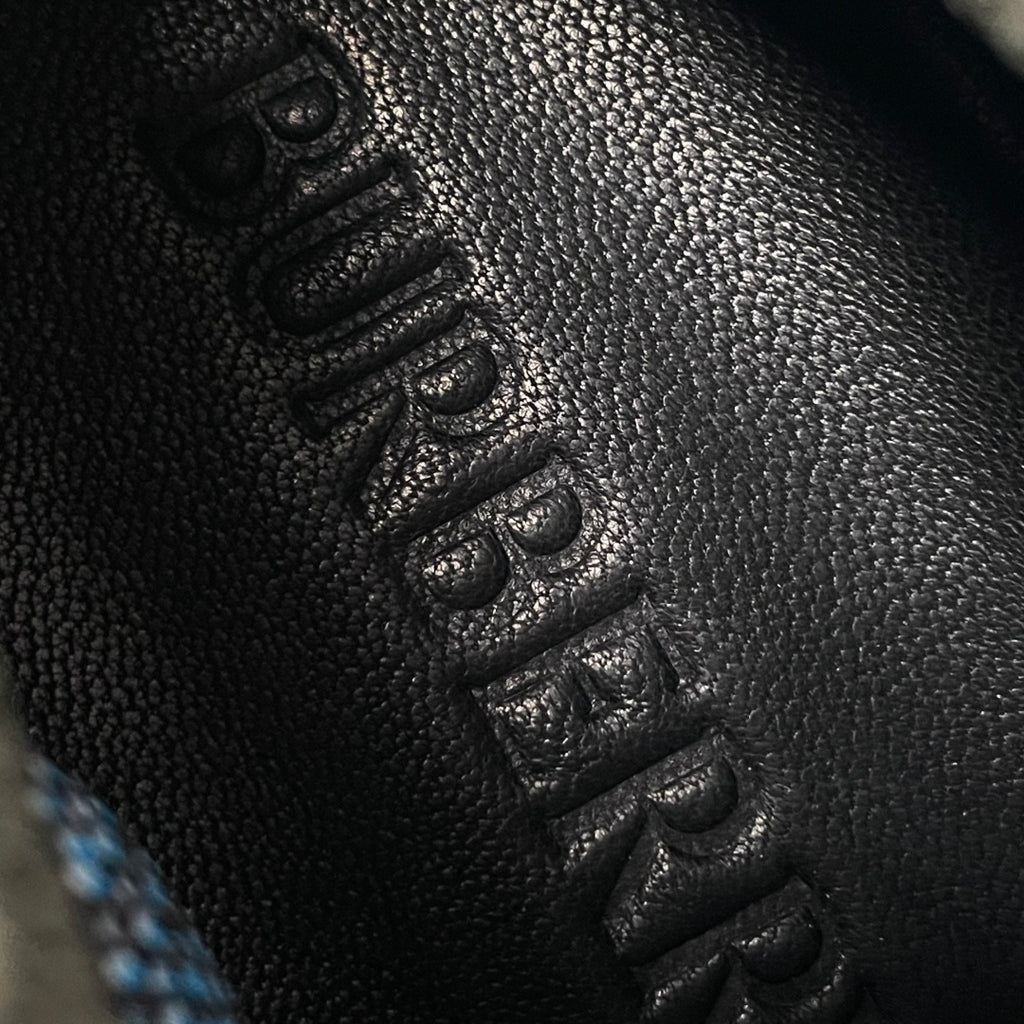 Burberry knit sneaker upper detail, dark textured fabric with lace eyelets