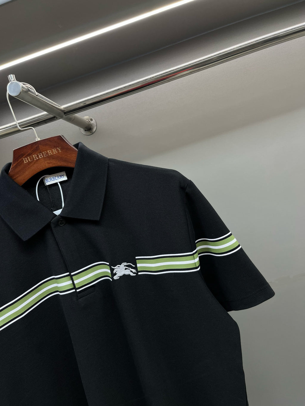 Burberry polo shirt detail: dark navy collar and green-striped chest panel
