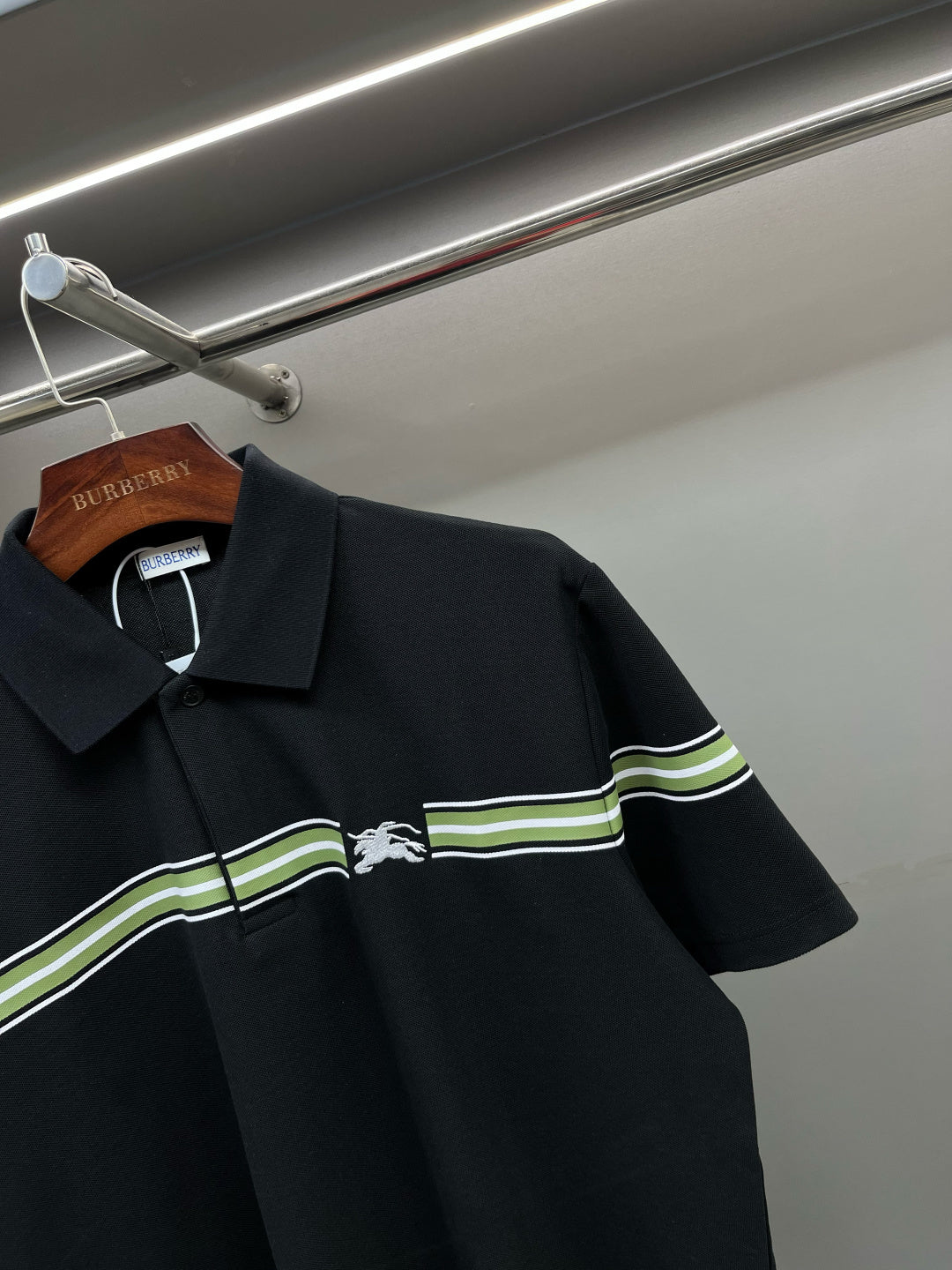 Burberry polo shirt detail: dark navy collar and green-striped chest panel