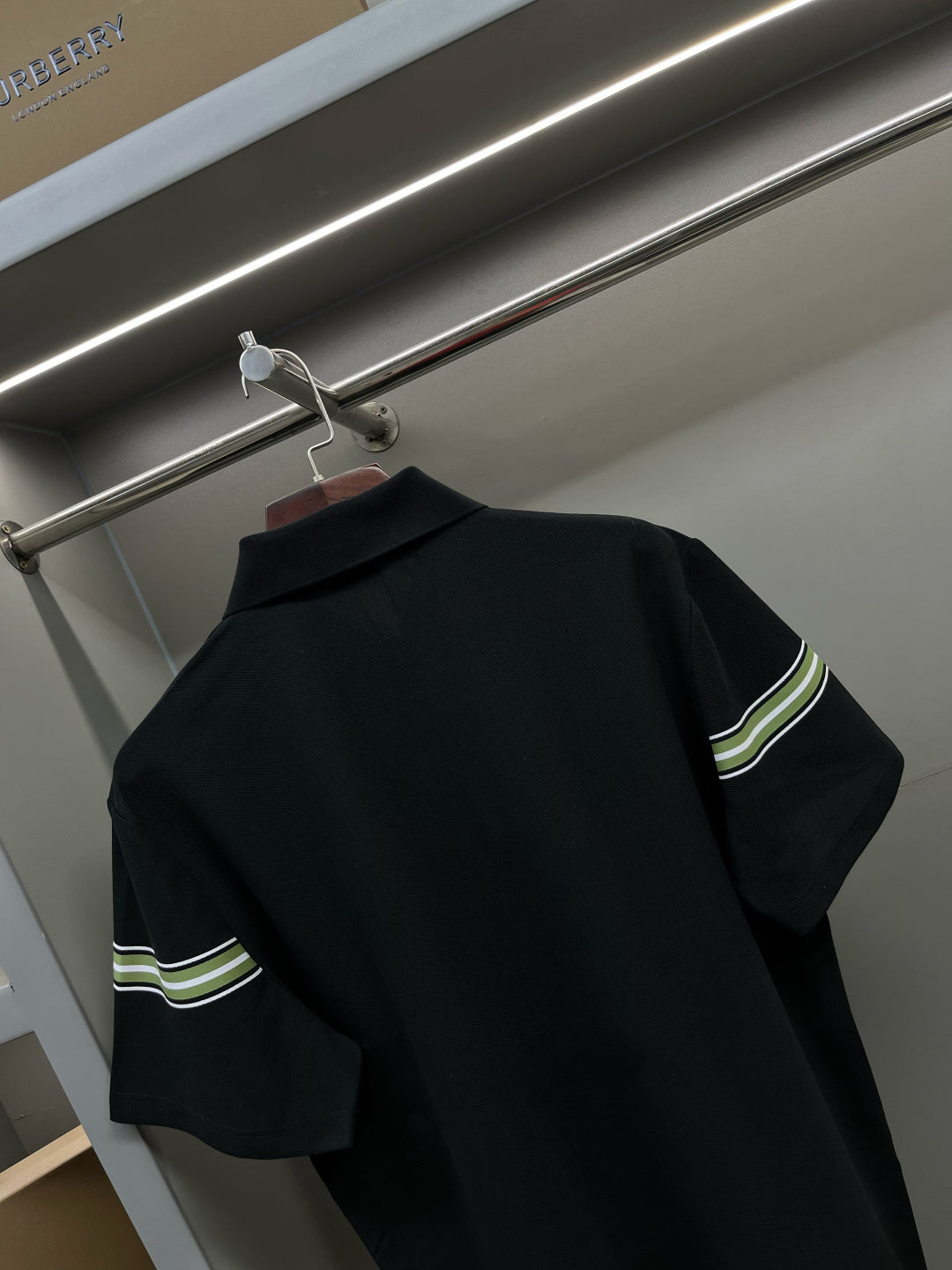 Burberry polo shirt back with dark navy fabric and green-striped sleeve bands