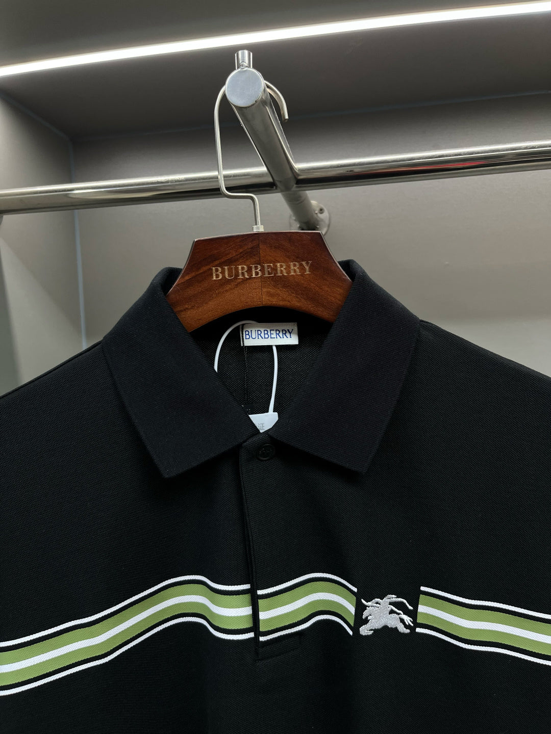 Burberry polo shirt with dark navy collar, button placket, and horse emblem