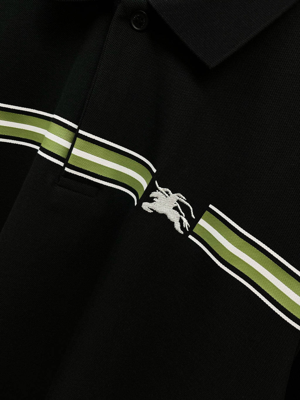 Burberry polo shirt chest close-up: dark navy stripes and white horse logo