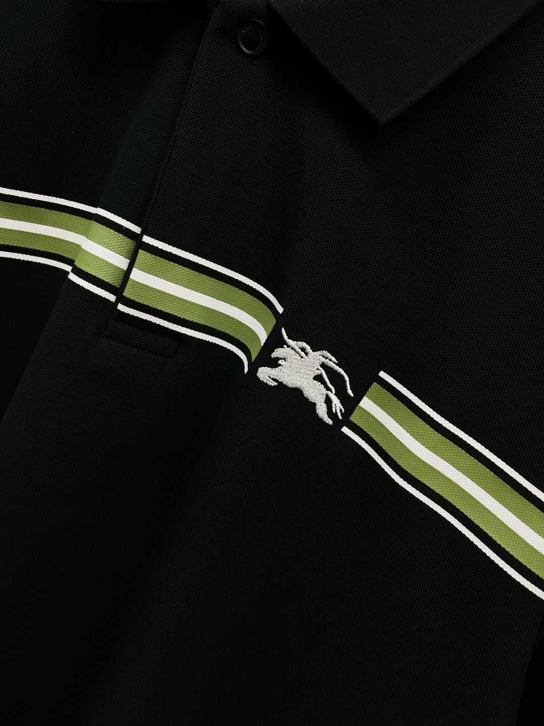 Burberry polo shirt chest close-up: dark navy stripes and white horse logo