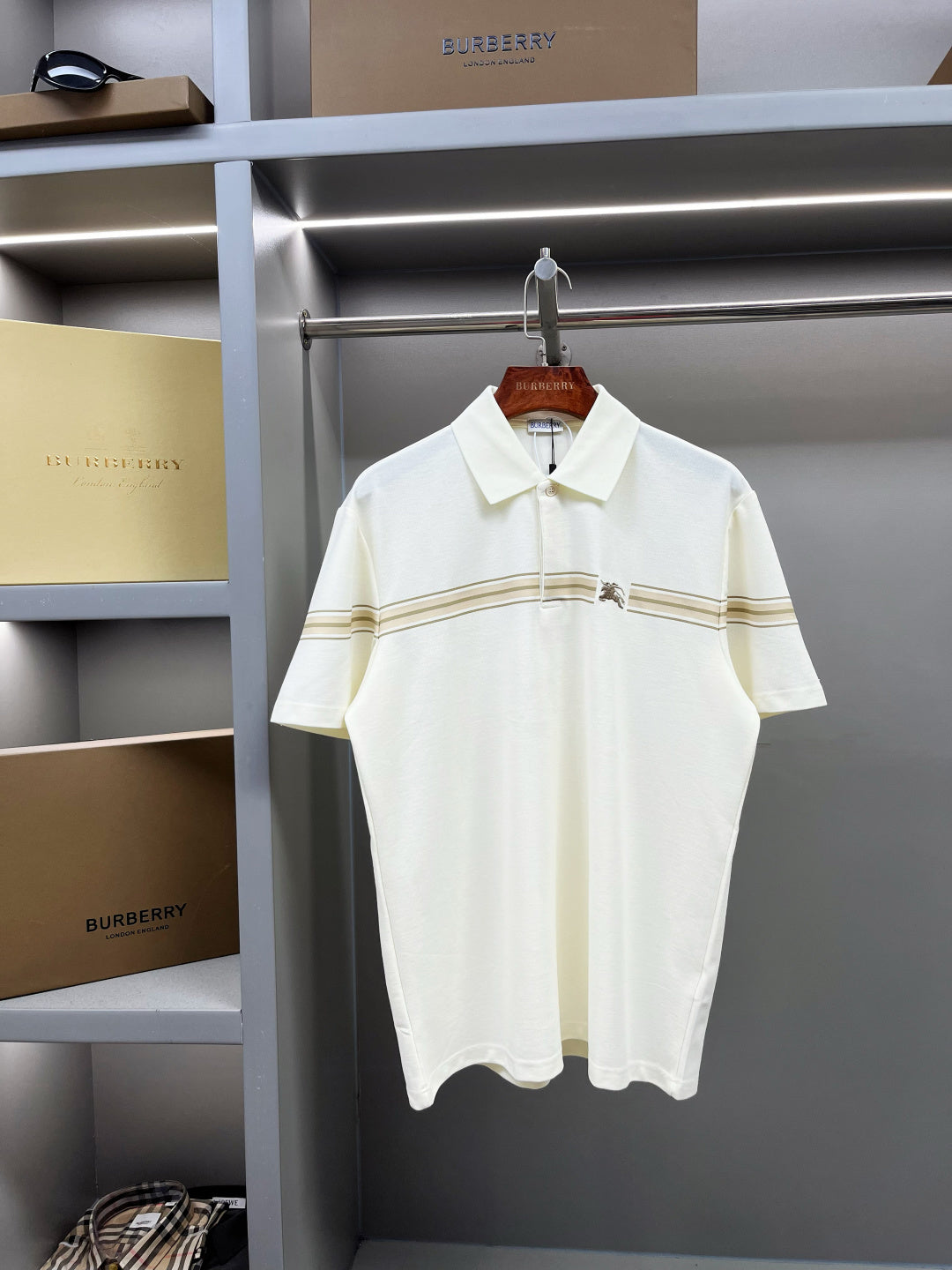 Burberry short-sleeve polo shirt in light cream with tan stripe trim and horse logo