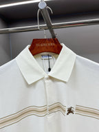 Burberry polo shirt with pointed collar, button placket, and tan-striped horse motif