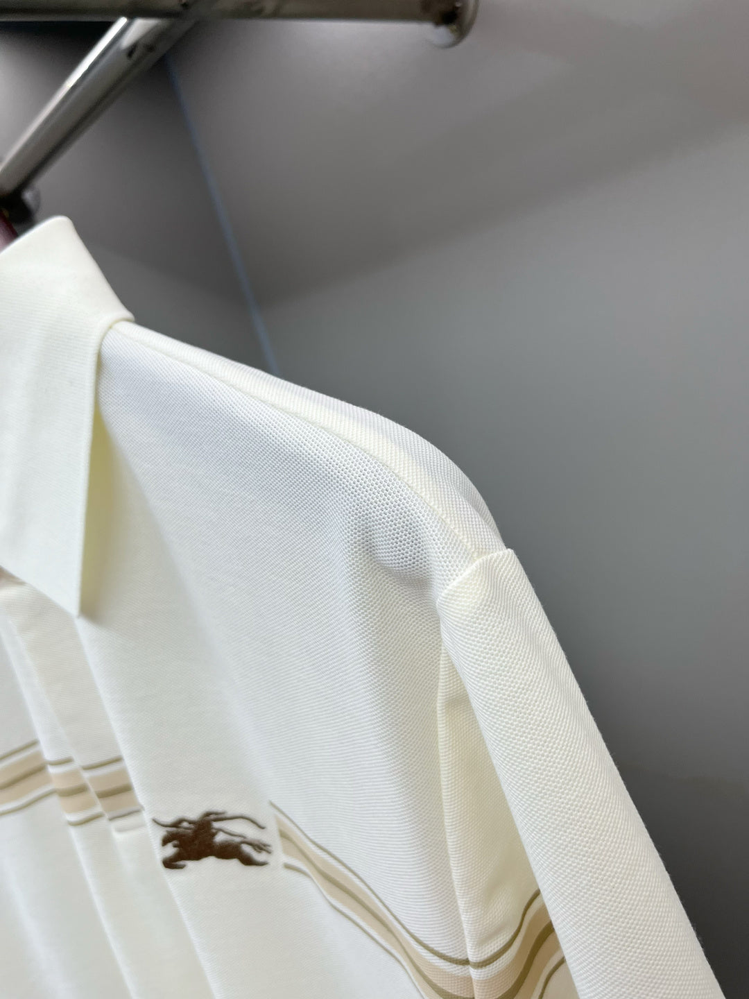 Burberry polo shirt sleeve with horse logo and tan stripe band detail