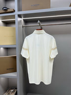 Burberry short-sleeve polo shirt in light cream with tan trim stripe and horse emblem