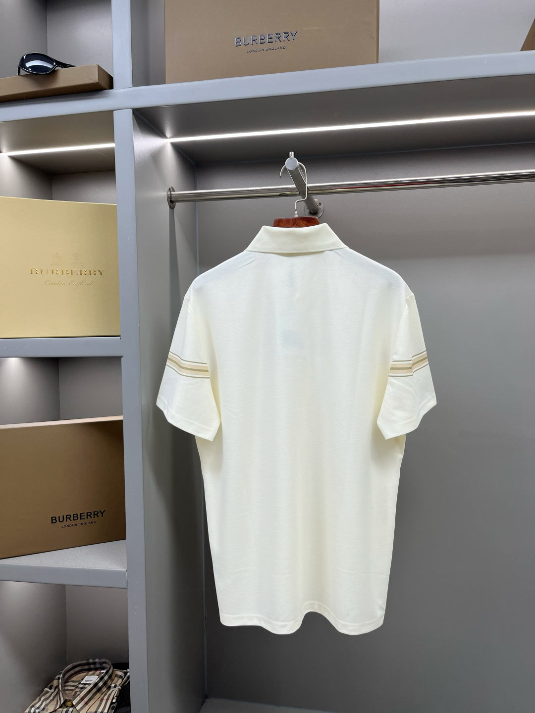 Burberry short-sleeve polo shirt in light cream with tan trim stripe and horse emblem