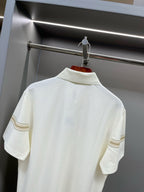 Burberry polo shirt back view with tan stripe bands at shoulders and collar area