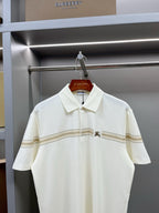 Burberry polo shirt with white collar, button placket, and tan-striped chest detail